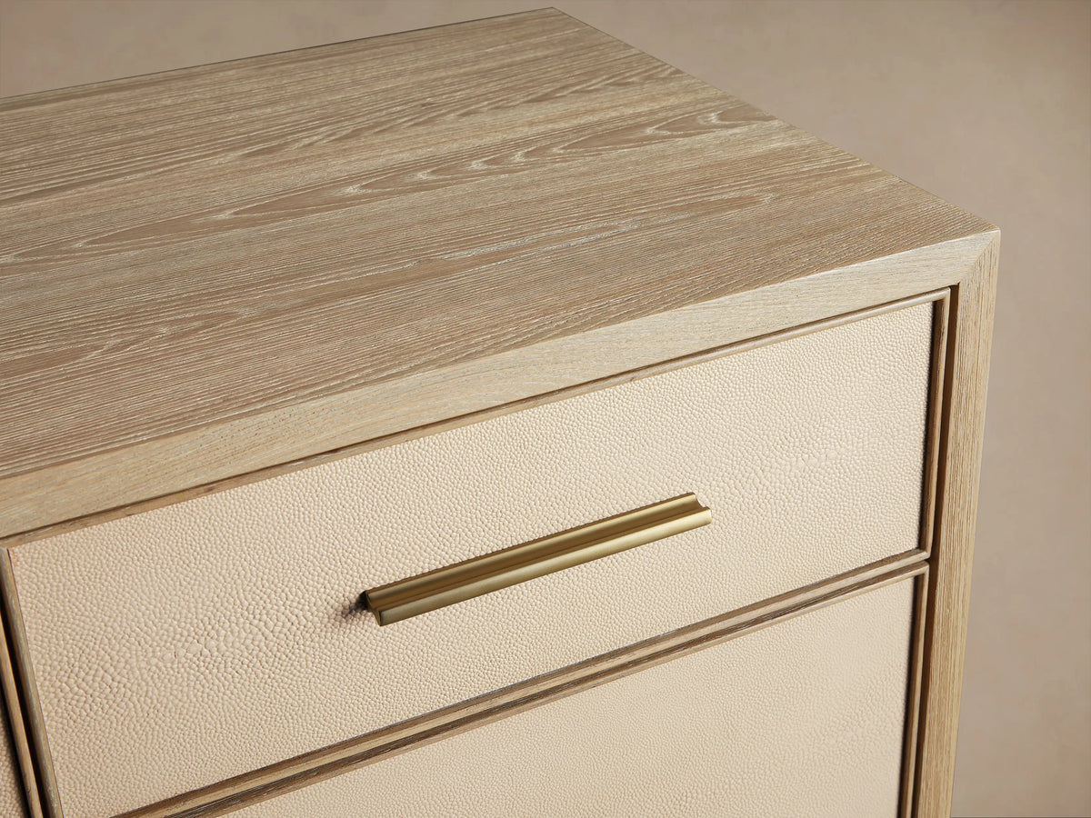 Front view of the Bone Malone Eleven-Drawer Dresser with shagreen textured drawers, metallic handles and base.