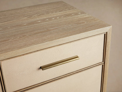 Front view of the Bone Malone Eleven-Drawer Dresser with shagreen textured drawers, metallic handles and base.