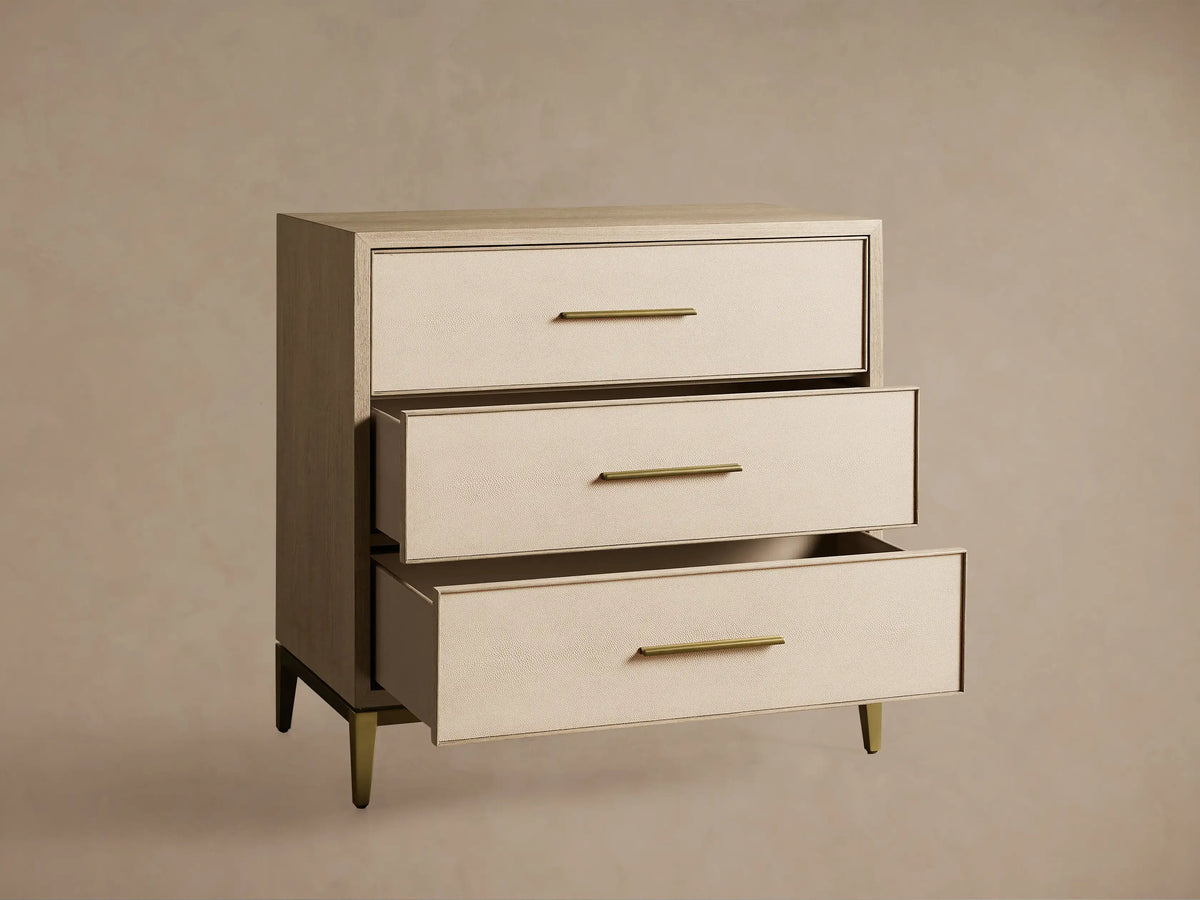 Malone Three-Drawer Chest in bone/manta, elm wood veneer frame, cream textured shagreen leather drawers, gold pulls & base.