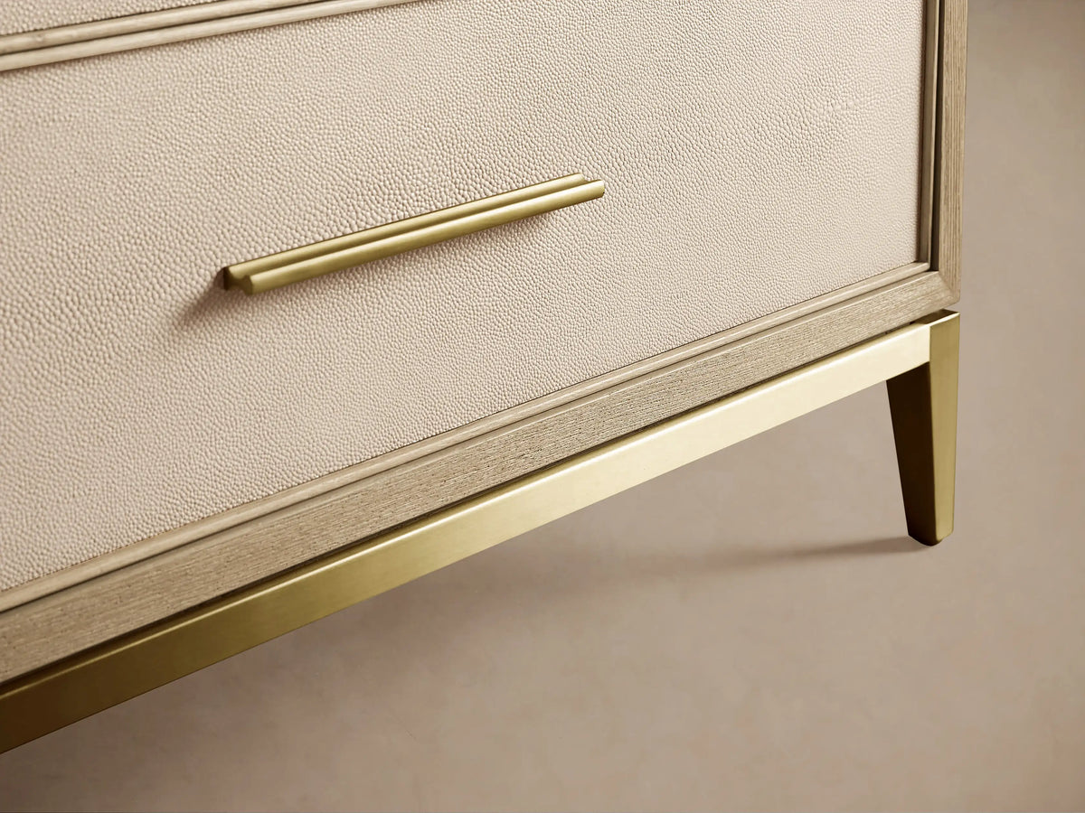 Malone Three-Drawer Chest with top drawer ajar, revealing bone/manta shagreen-textured leather front, light wood frame, metallic handle.