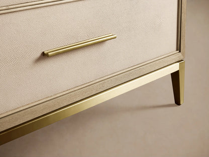 Malone Three-Drawer Chest with top drawer ajar, revealing bone/manta shagreen-textured leather front, light wood frame, metallic handle.