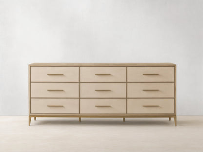 Front view of the Bone Malone Nine-Drawer Dresser, featuring nine drawers with embossed shagreen faces and metallic bar handles.