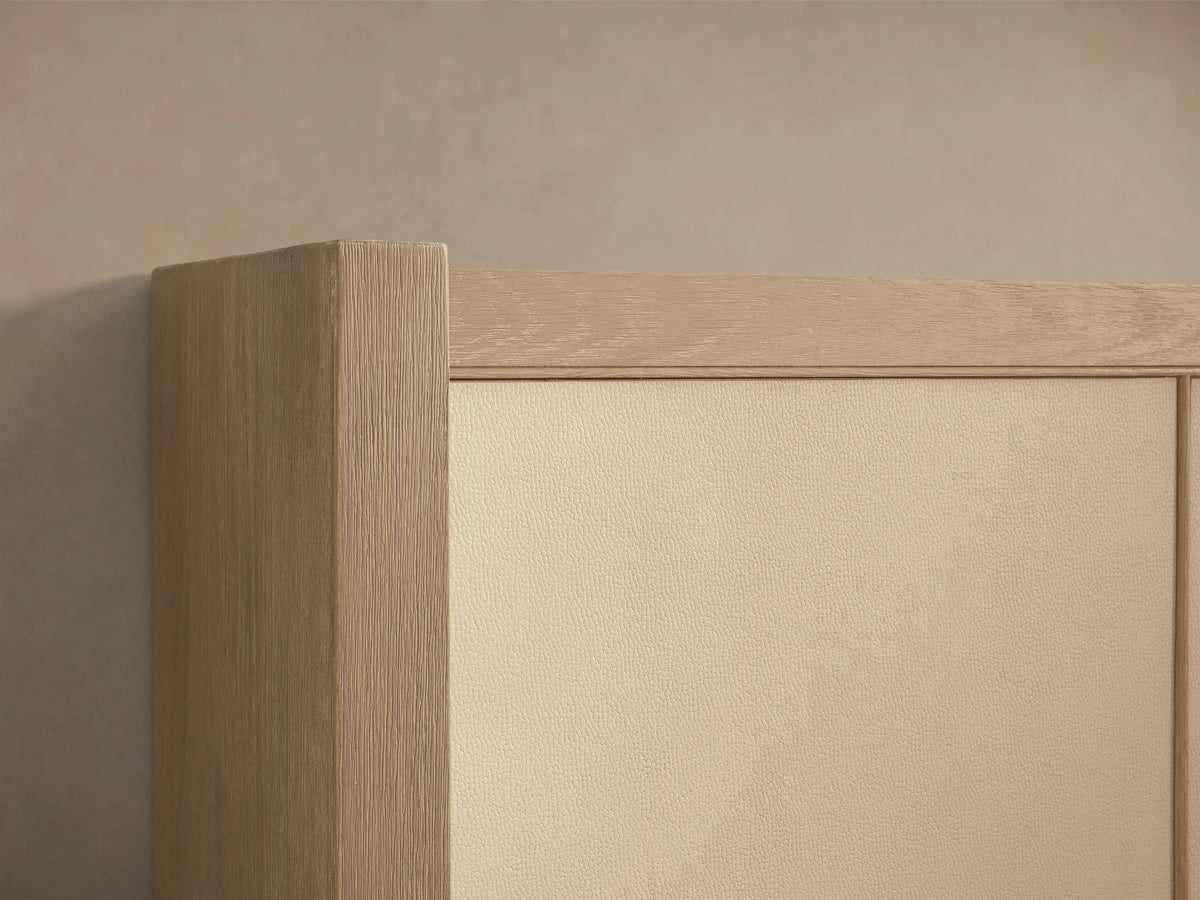 Front view of the Malone Shelter Bed with a Bone finished oak wood frame, cream headboard panels, and crisp white bedding.