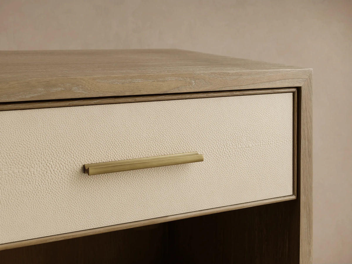 Close-up of the Bone Malone Open Nightstand with a cream shagreen drawer front and a brass pull handle.