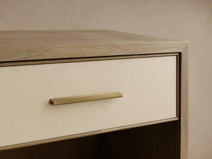 Close-up of the Bone Malone Open Nightstand with a cream shagreen drawer front and a brass pull handle.