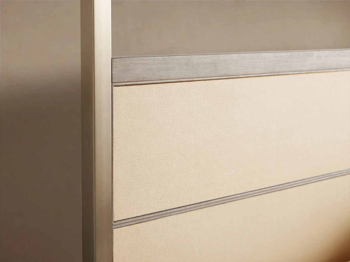 Front view of Malone Canopy Bed with light wood base, light beige shagreen leather headboard, and dark metallic canopy frame. Dressed in white bedding.