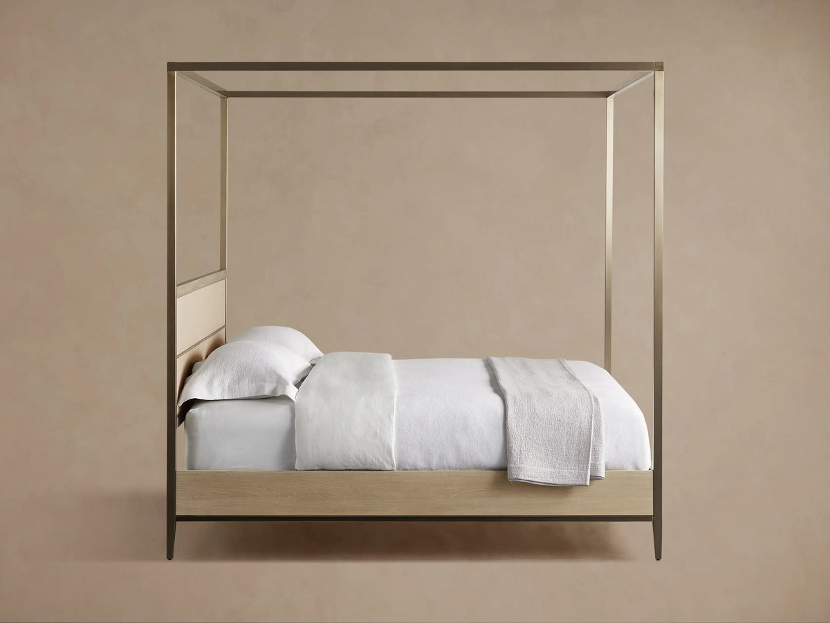 Close-up of cream reconstituted leather inset with shagreen detailing and metallic accent on the Malone Canopy Bed.