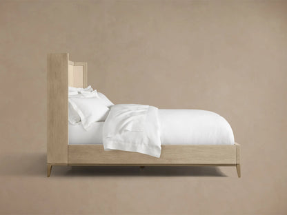 Close-up of the Malone Shelter Bed's light oak wood frame and bone-colored shagreen-embossed leather inset.