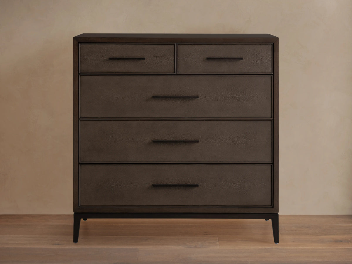 Malone Five-Drawer Dresser in dark wood finish with five drawers, featuring metal handles and a sleek, rectangular design on a wooden floor.