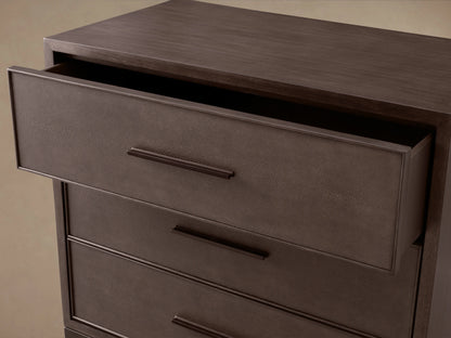 Malone Three-Drawer Chest in dark brown with textured fronts and dark handles, bottom drawer slightly open.
