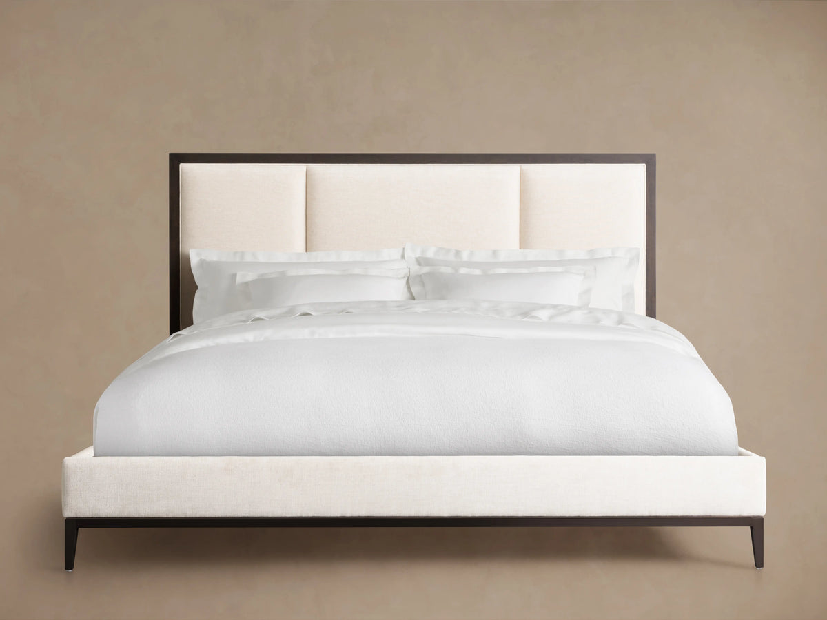 Malone Upholstered Bed in Sparrow wood with Bone upholstered headboard panels, white bedding, and Bone upholstered base.