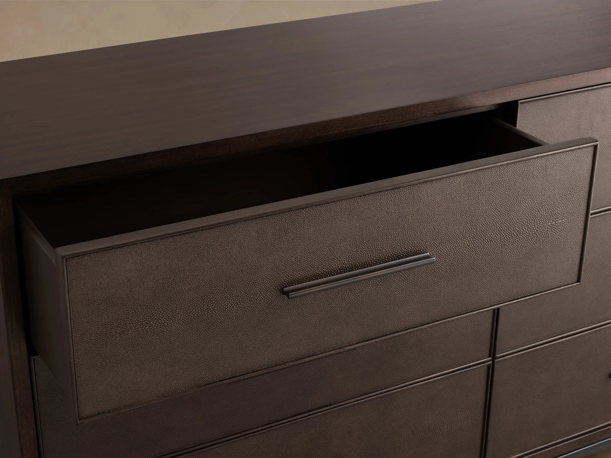 Malone Six-Drawer Dresser in dark wood finish with six drawers, each featuring sleek dark handles, on tapered legs against a neutral backdrop.