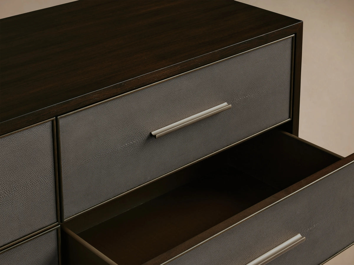 Malone Nine-Drawer Dresser with dark wood finish, featuring reconstituted leather insets with textured detailing and metallic handles.
