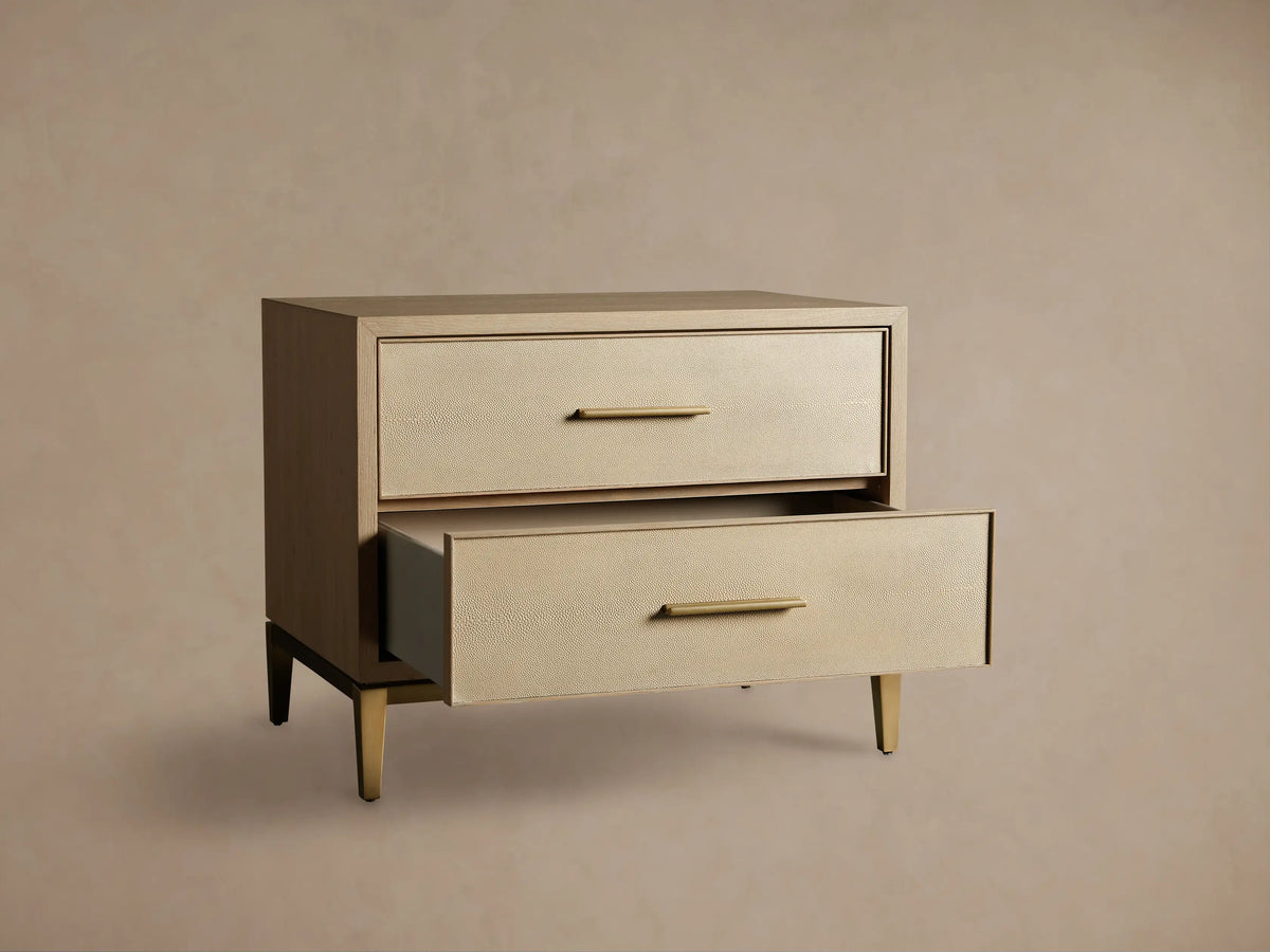 Front-right view of Bone Malone Closed Nightstand, with light oak frame and two shagreen leather drawers, one open, on metallic legs.