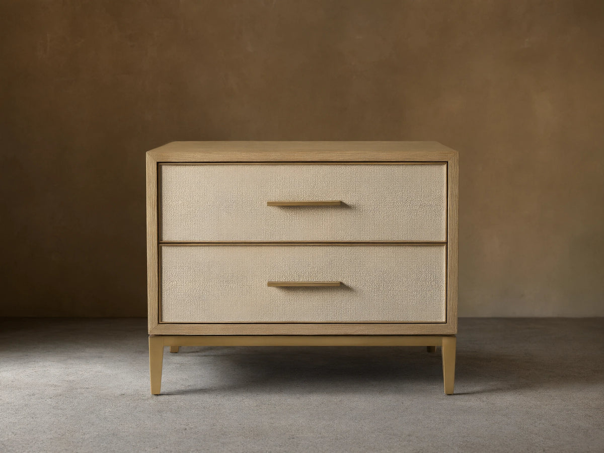 Front view of the Bone Malone Closed Nightstand with two cream shagreen leather drawers and brass hardware.