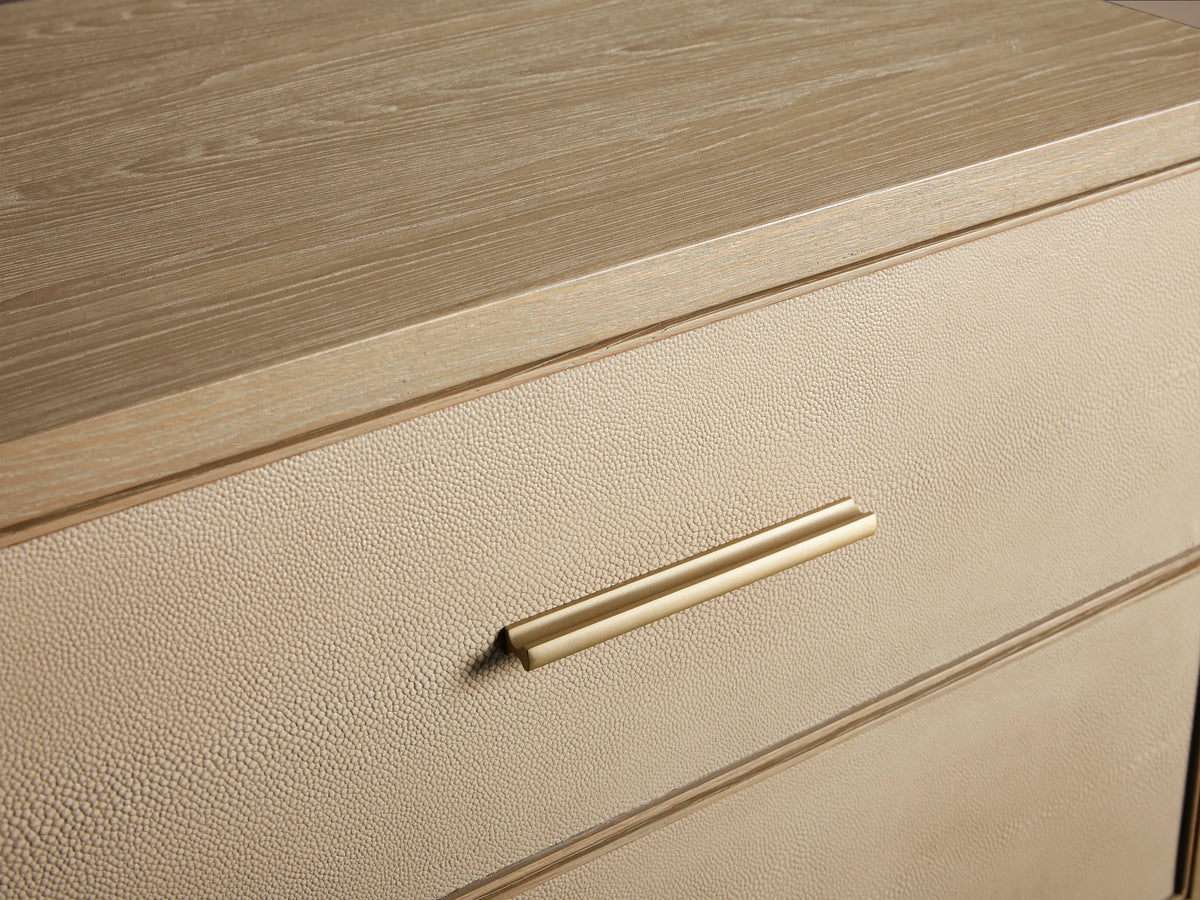 Front 3/4 view of the Bone Malone Closed Nightstand, featuring two drawers with shagreen-textured fronts and metallic gold hardware.