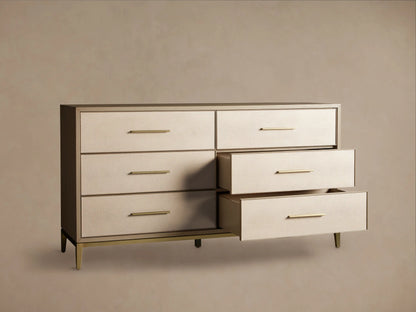 Front view of the Malone Six-Drawer Dresser with light beige shagreen leather drawer fronts, a dark brown frame, and warm gold metallic pulls and base.