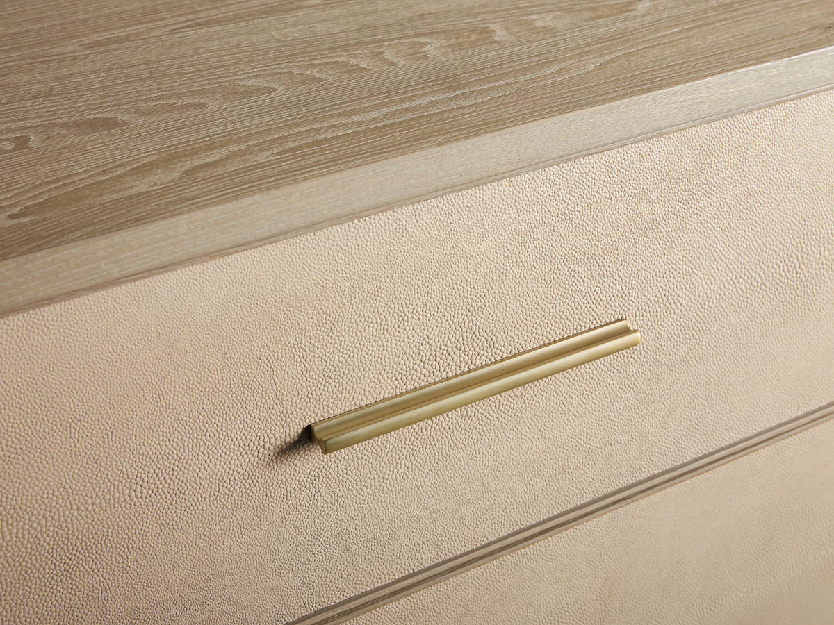 Front view of the Bone Malone Six-Drawer Dresser with gold handles and legs, two right drawers partially open.