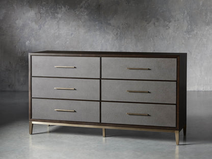 Front view of the Malone Six-Drawer Dresser, dark wood frame, six gray shagreen drawers, and warm metallic pulls and base.