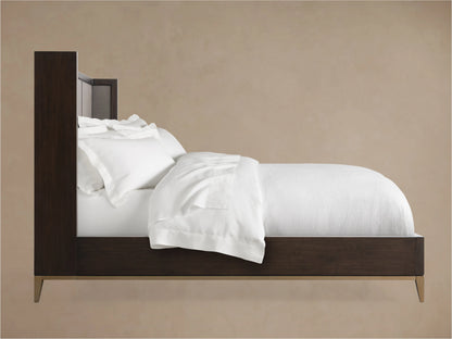 Malone Shelter Bed, side view, dark sparrow wood frame, dark inset headboard, white bedding, metallic feet.