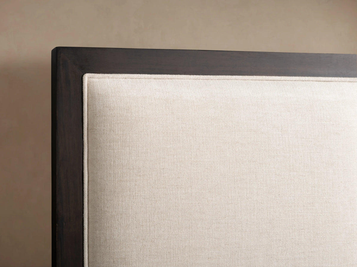 Malone Upholstered Bed with a neutral-toned upholstered headboard featuring three channel-stitched panels and wood frame accents.