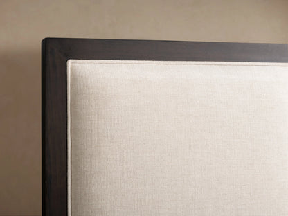 Malone Upholstered Bed with a neutral-toned upholstered headboard featuring three channel-stitched panels and wood frame accents.