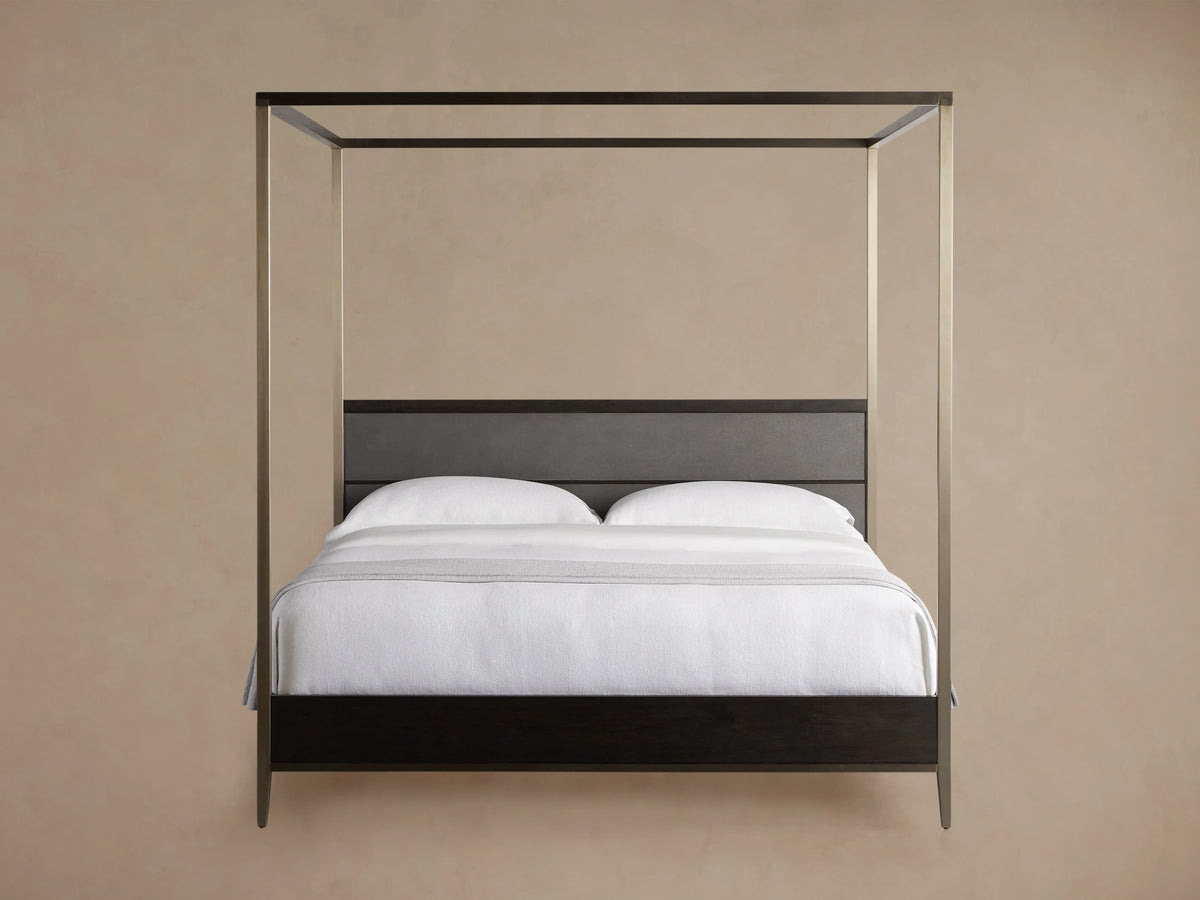 Malone Canopy Bed: Dark espresso wood frame, gray shagreen headboard, metallic champagne canopy. White bedding, light gray throw.