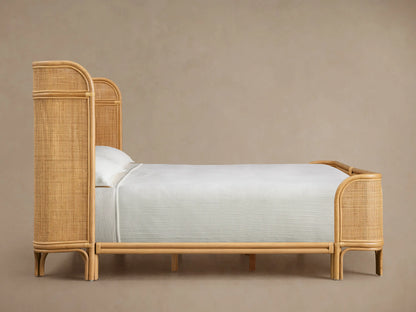 Close-up of Maya Bed headboard, featuring curved light brown rattan cane frame and intricate woven rattan mesh panels.