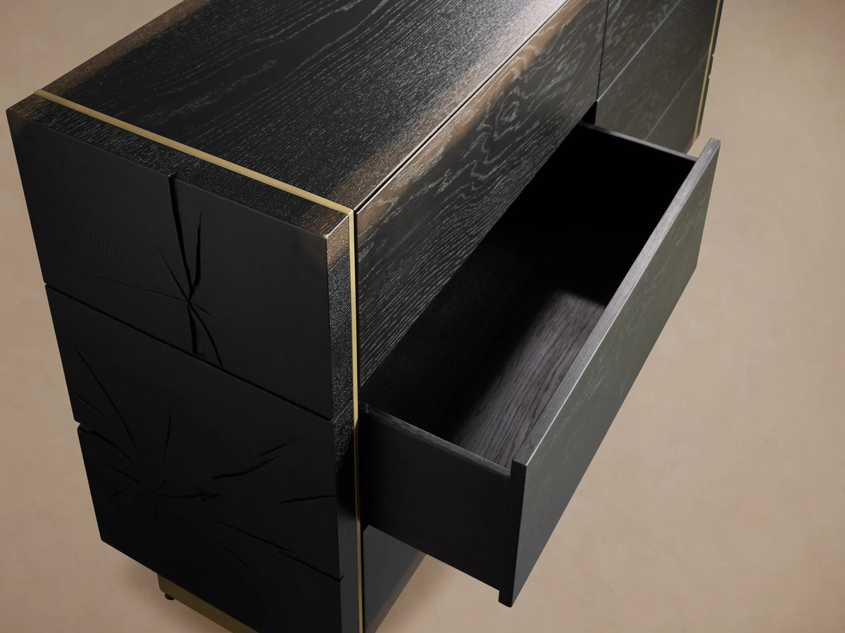 Mihaela Six-Drawer Dresser in dark oak with one drawer open, showing hand-carved detailing and brass-like accents.