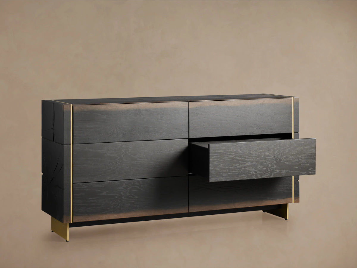 Mihaela Six-Drawer Dresser made of dark Romanian oak with brass accents; one drawer is partially open, showcasing sleek design.