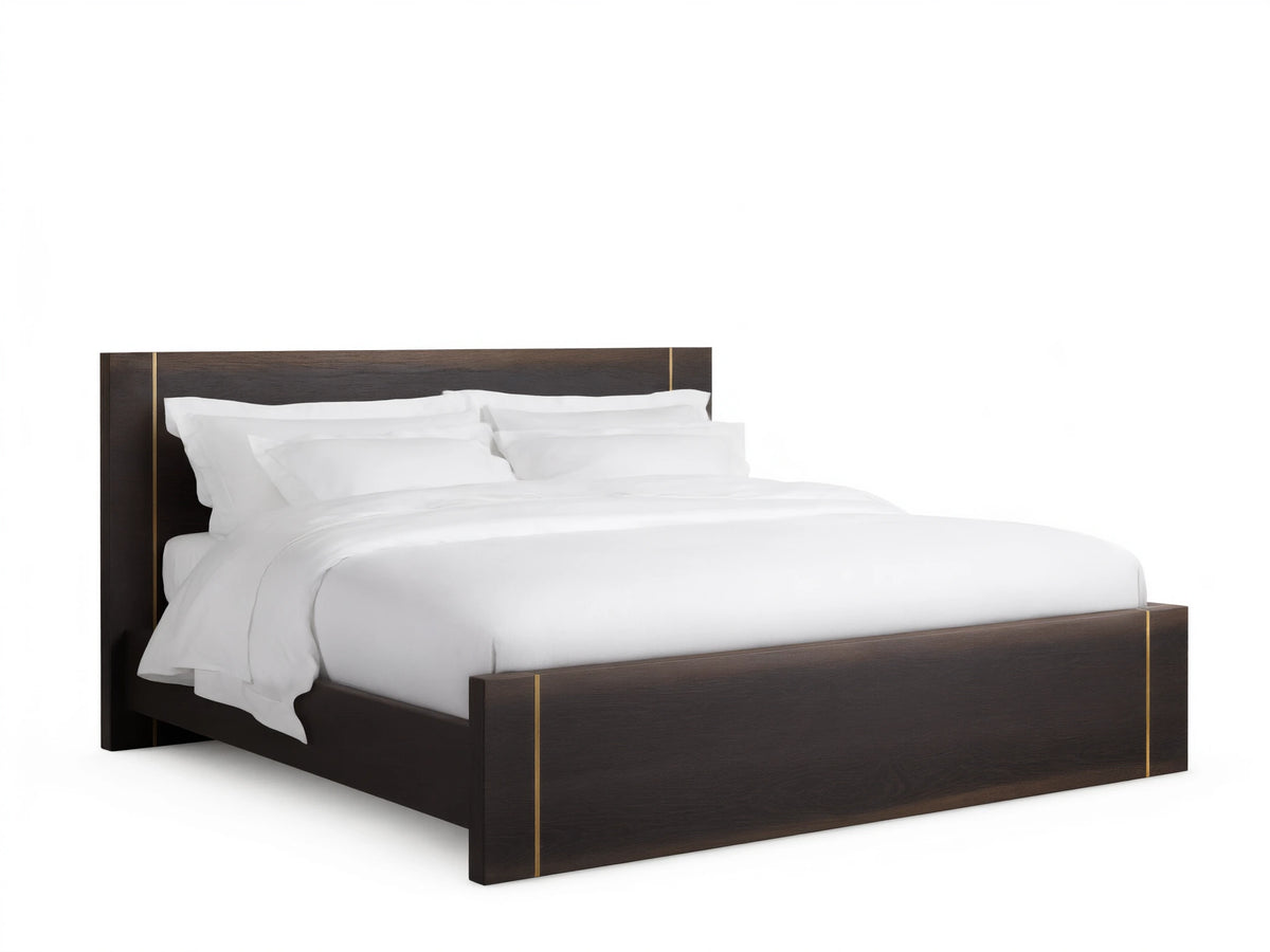 Mihaela Bed with dark oak frame, metallic brass accents, white bedding, on a wooden floor, set against a beige wall.