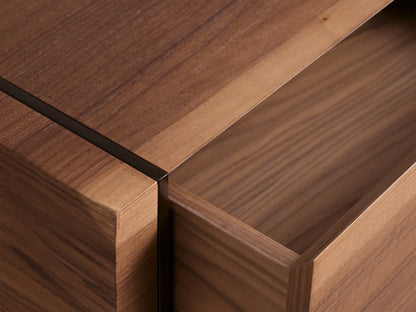 Mihaela Nightstand: Modern, two-drawer nightstand in warm walnut veneer with dark vertical trim and black angular metal base.