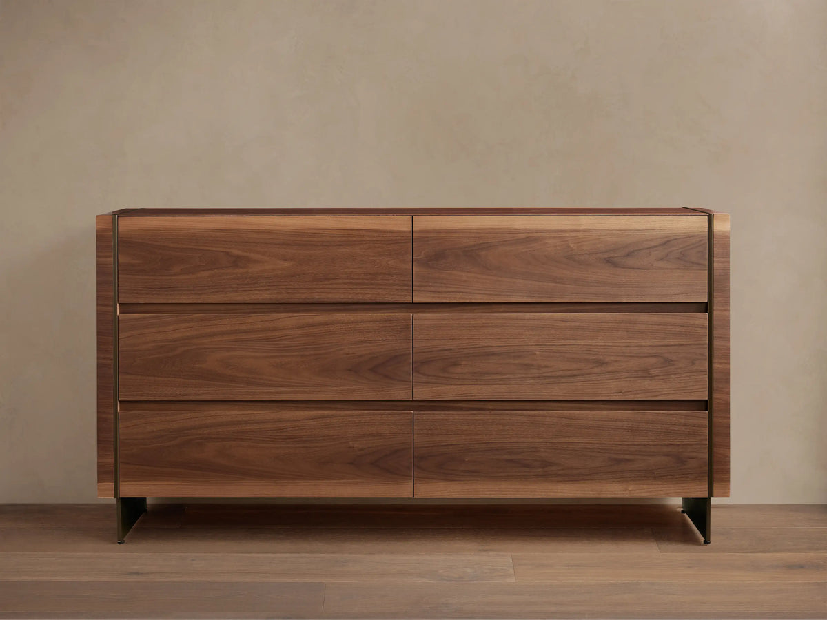 Mihaela Six-Drawer Dresser. Dark walnut veneer with six drawers, subtle metallic trim, on a wood floor.
