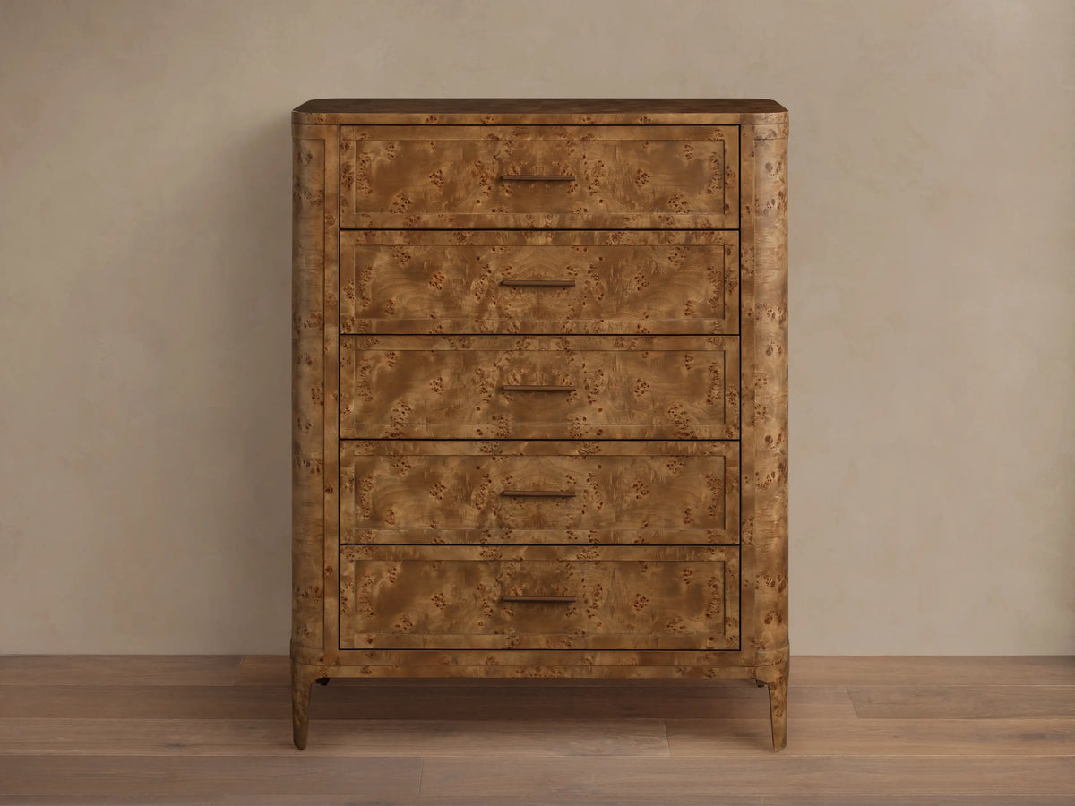 Front view of the brown Mogadore Five-Drawer Dresser, showcasing its mappa burl wood grain, five drawers, and antiqued brass pulls.