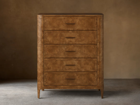 Front view of the brown Mogadore Five-Drawer Dresser, showcasing its mappa burl wood grain, five drawers, and antiqued brass pulls.