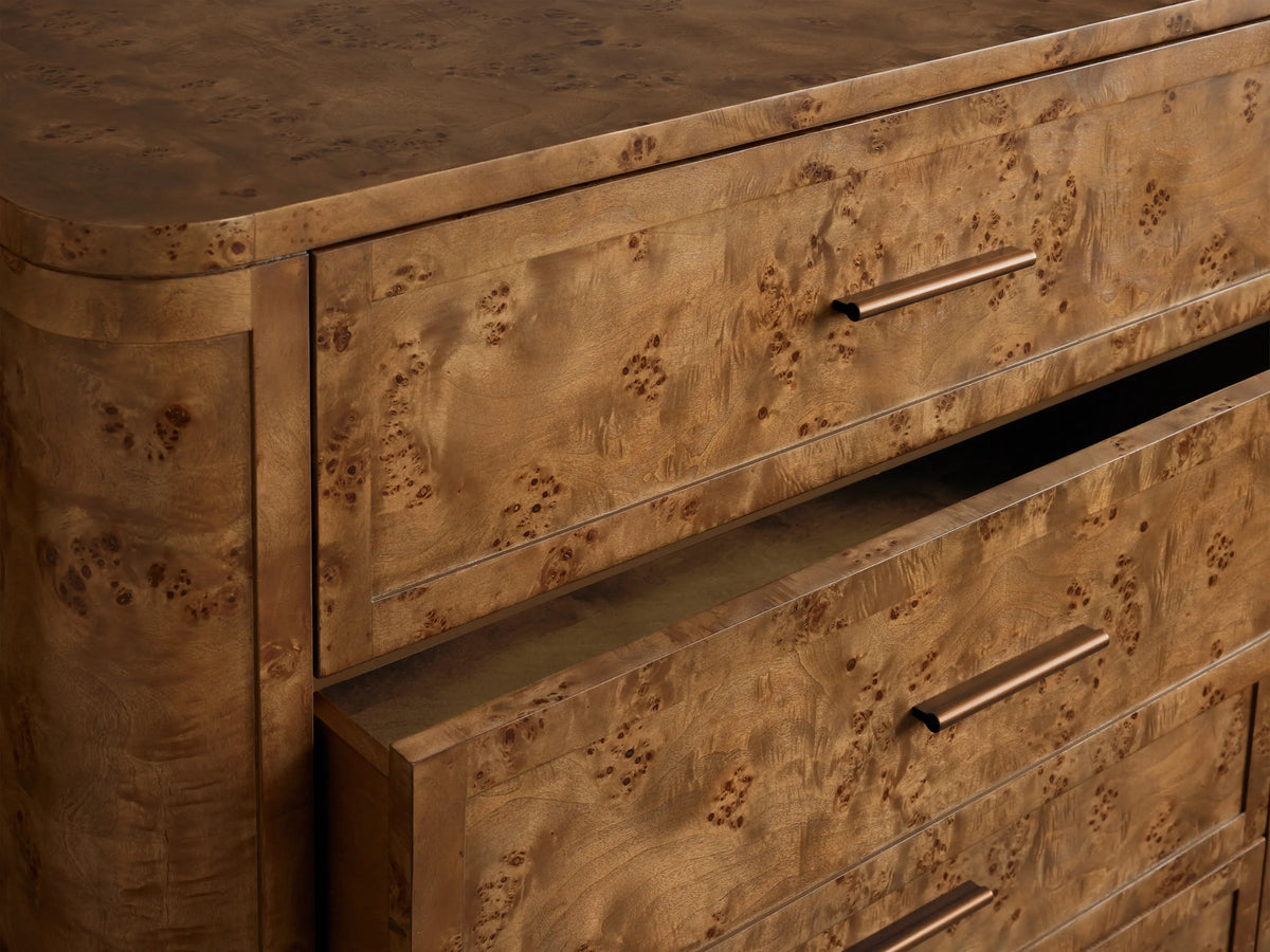Front view of the light brown Mogadore Five-Drawer Dresser, crafted from book-matched Mappa burl wood, with antiqued brass handles.