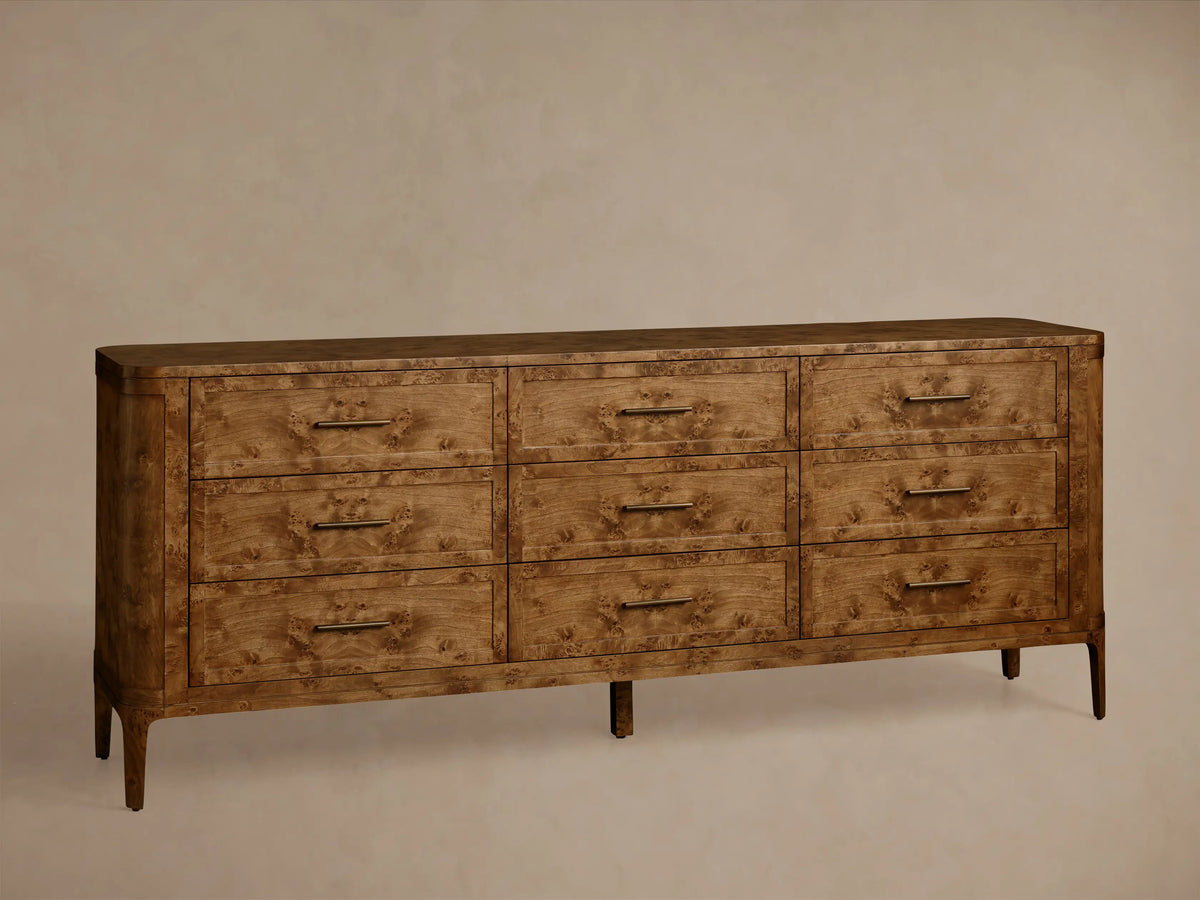 Front view of the Mogadore Nine-Drawer Dresser, made from brown mappa burl wood, featuring nine drawers with antiqued brass pulls.