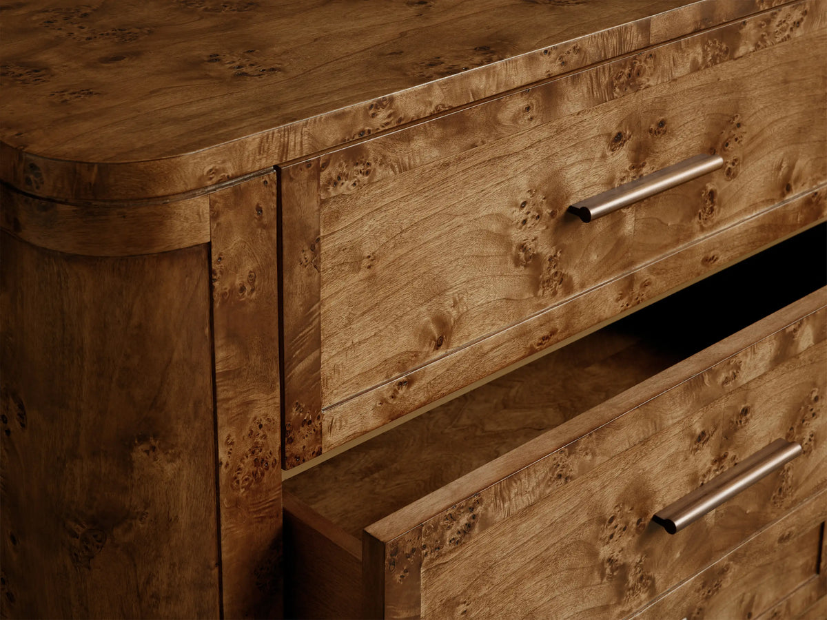 Front view of the Mogadore Nine-Drawer Dresser crafted from Mappa burl wood with antiqued brass hardware and curved legs.