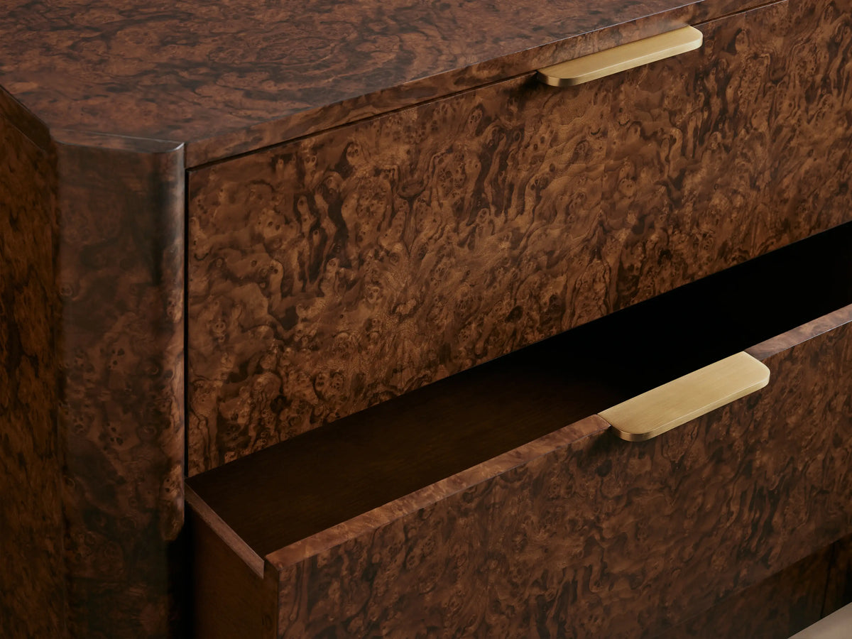 Wooden dresser with six drawers, featuring a rich brown textured finish and gold handles. Placed against a taupe background.