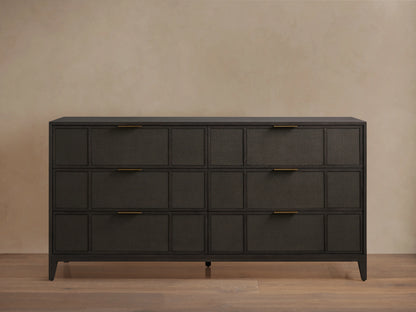 Olina Six-Drawer Dresser with dark oak finish, featuring raffia-textured front panels, six drawers, and brass pulls on wooden floor.