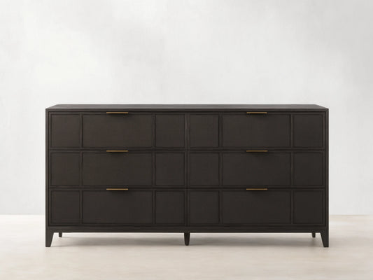 Olina Six-Drawer Dresser with dark oak finish, featuring raffia-textured front panels, six drawers, and brass pulls on wooden floor.