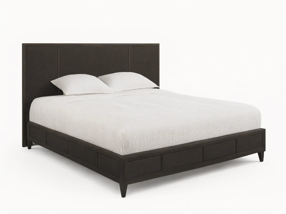 Front view of the dark brown Olina Bed, featuring a textured raffia headboard and footboard, with white bedding.
