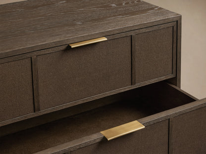 Olina Closed Nightstand with dark oak finish, textured raffia fronts, and brass drawer pulls, one drawer open showing interior.