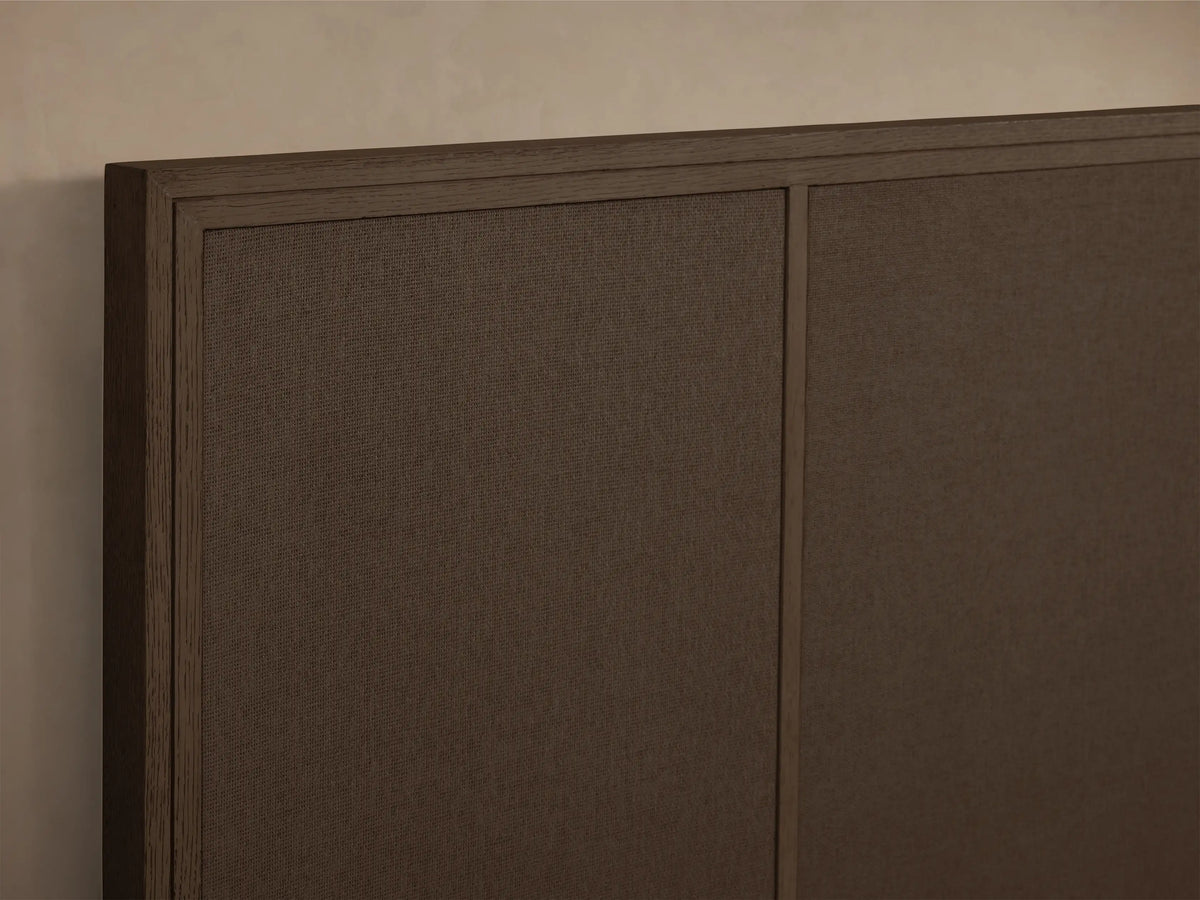 Front view of the dark brown Olina Bed, featuring raffia panels on headboard and footboard.