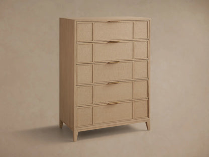 Close-up of the light wood Olina Five-Drawer Dresser. One textured raffia drawer with a brass pull is partially open.