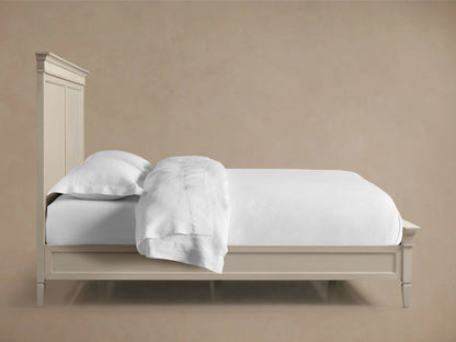 Ottavia Bed corner view showing a cream-colored headboard with ornate ridged detailing along the top edge.