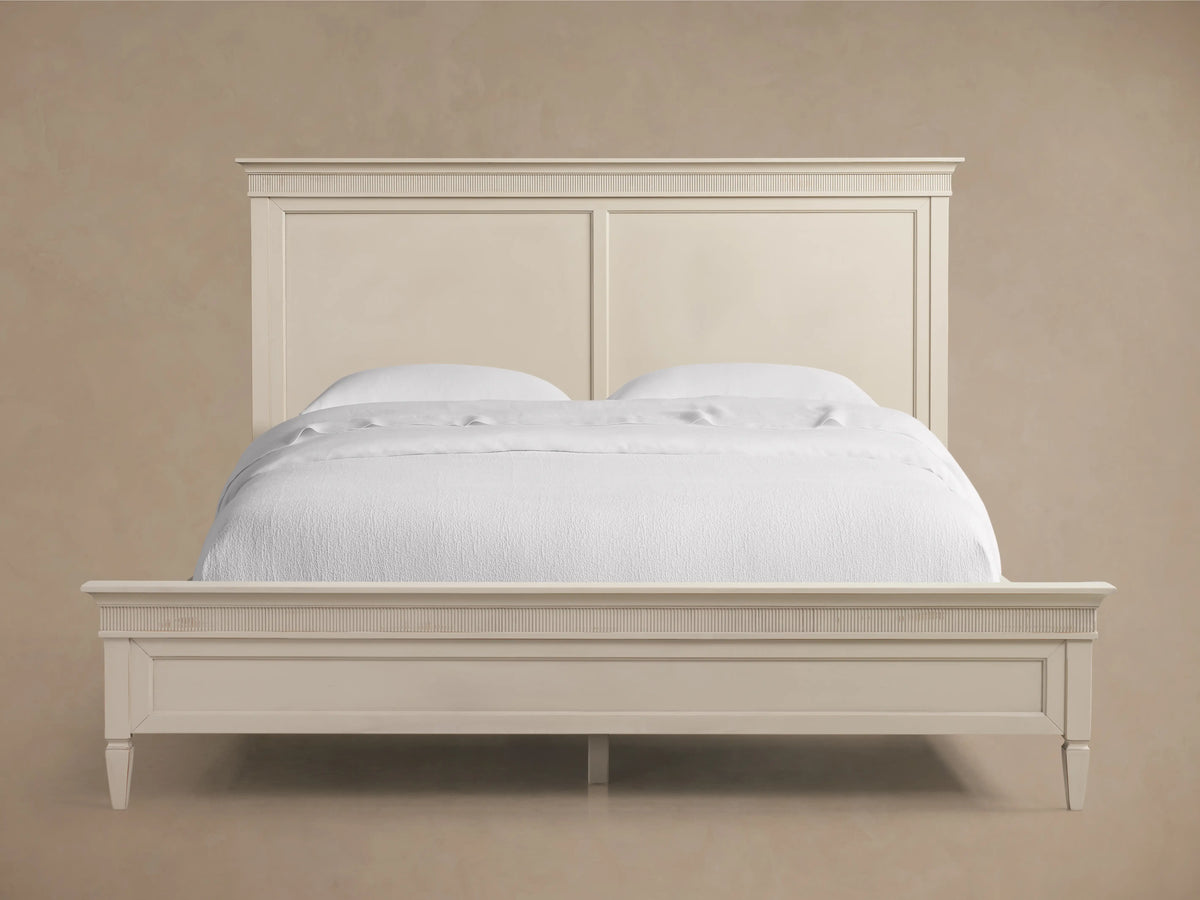 Ottavia Bed headboard made of light-colored Tanganika wood, featuring ribbed detailing near the top and a smooth, flat panel below.
