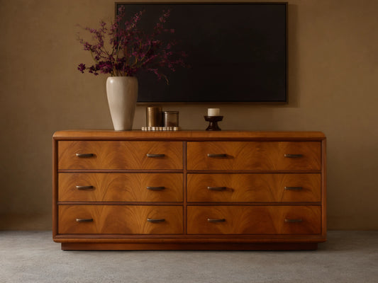 Front view of the brown Palma Six-Drawer Dresser, showcasing distinctive cerajeira veneer graining and aged bronze hardware.