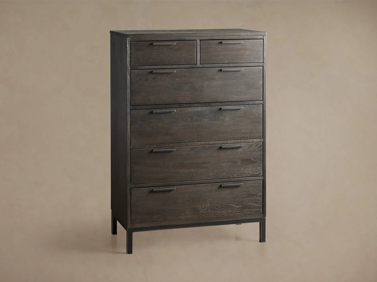 Palmer Six-Drawer Dresser in dark wood finish with black metal handles and frame, set against a neutral wall and wooden floor.