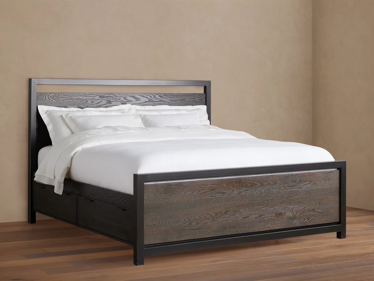 Palmer Storage Bed in a neutral room, featuring a solid wood frame with visible grain, black metal accents, and white bedding.